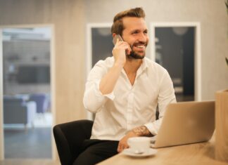 Criterion For The Choice Of A Stockbroker For Your Business! man using smartphone on chair