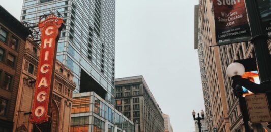 Learn 11 Interesting Facts About the State of Illinois different vehicles on road near Chicago city buildings
