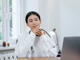How To Become A Nurse Leader Free A Woman Sitting with Stethoscope Stock Photo