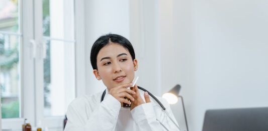 How To Become A Nurse Leader Free A Woman Sitting with Stethoscope Stock Photo
