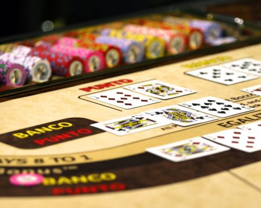 Baccarat vs. Blackjack: Differences and Similarities Between the Two Games white red and black game board