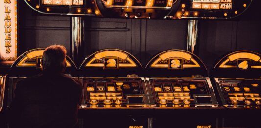 How To Define RTPs: Brief Instruction For Beginners man playing arcade machine