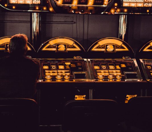 How To Define RTPs: Brief Instruction For Beginners man playing arcade machine