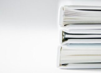 How Important Are Certified Translations in Today’s Globalised World? A stack of thick folders on a white surface