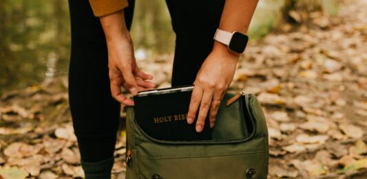 Tips And Tricks For Organizing Your Backpack person holding green and black backpack