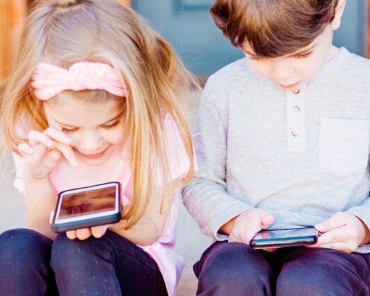 The Best Way to Control Children Using the Android Locator App girl and boy using Android smartphones