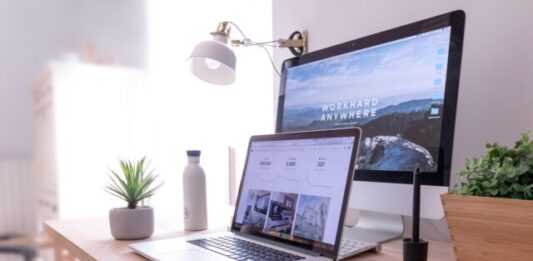 8 Ways to Boost Your PC’s Performance MacBook Pro on table beside white iMac and Magic Mouse