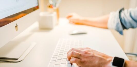 Salesforce Experience Cloud Site: Setup and Management Guide person using iMac