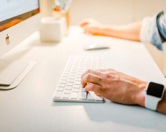 Salesforce Experience Cloud Site: Setup and Management Guide person using iMac