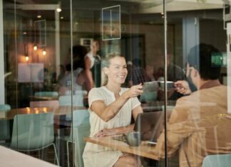 How to Start Correspondence With a Girl? woman in white shirt sitting at coffee shop with man in brown jacket