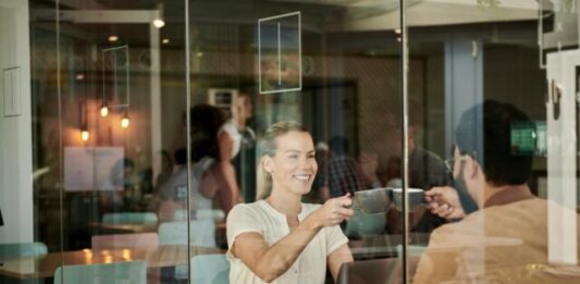 How to Start Correspondence With a Girl? woman in white shirt sitting at coffee shop with man in brown jacket