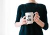 How to Invest in Yourself to Advance Your Career woman holding white mug while standing