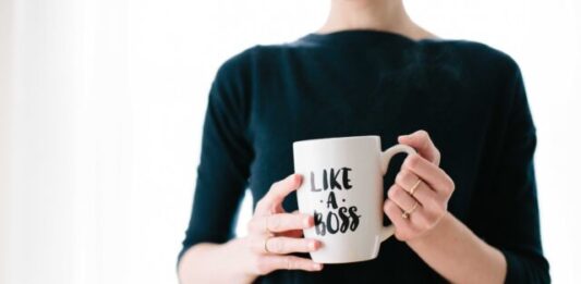 How to Invest in Yourself to Advance Your Career woman holding white mug while standing
