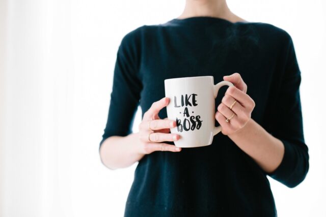 Photo by Brooke Lark woman holding white mug while standing