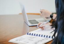 Merchant Cash Advance: The Right Choice for Your Business? person holding pen writing on paper