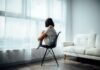 How Depression Takes Control of Your Life: Signs, Diagnosis, and Treatment Plans woman sitting on black chair in front of glass-panel window with white curtains