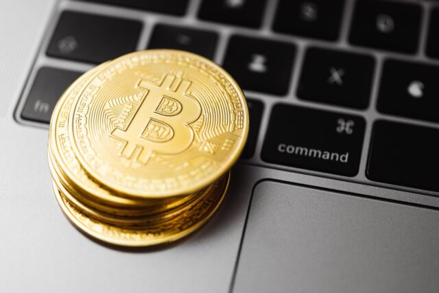Photo by Karolina Grabowska Stacks Gold Round Coins on Laptop