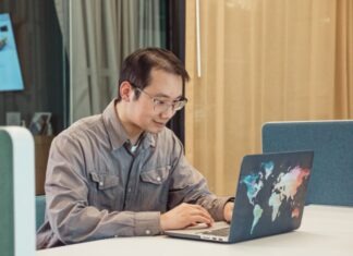 Online Betting in Singapore – Is Online Gambling Legal? A Man in Gray Sleeves Using a Laptop