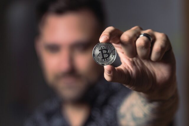 Photo by Crypto Crow Person Holding Silver Bitcoin Coin