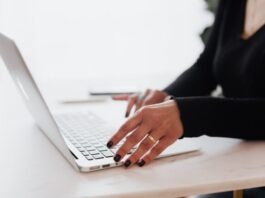 Steps to Choose Best Virtual Event Platforms Crop unrecognizable female entrepreneur in casual clothes using touchpad on laptop while working at table in contemporary office