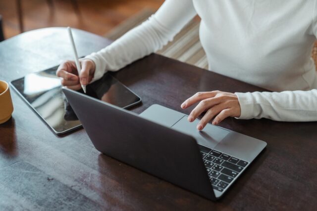 Photo by Ketut Subiyanto Crop faceless female entrepreneur doing multitasking work on different devices