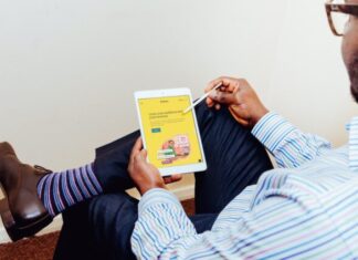5 Best Smart Marketing Tools To Enhance Audience Engagement a man holding a tablet