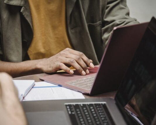 Top 5 Affordable Essay Writing Services to Save Your Money Crop faceless diverse male colleagues working on netbooks in office