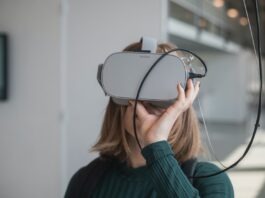 The Ultimate VR Experience: Exploring the World of Interactive VR Porn woman in black sweater holding white and black vr goggles