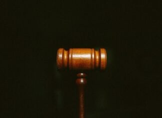 Evaluating Law Firms in Personal Injury Cases: Key Factors to Consider brown wooden stand with black background