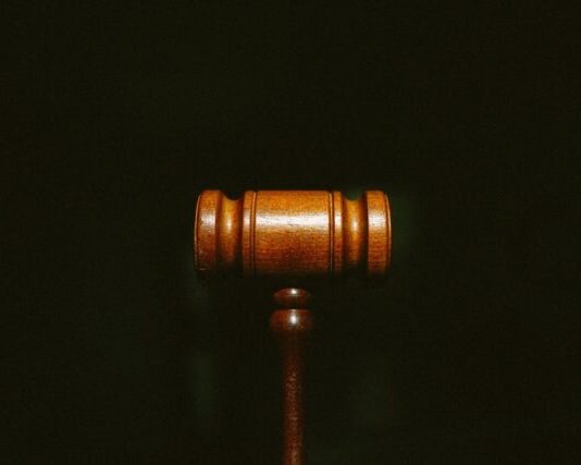 Evaluating Law Firms in Personal Injury Cases: Key Factors to Consider brown wooden stand with black background