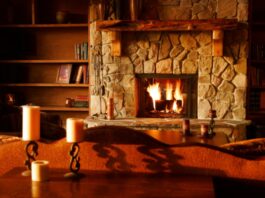 How to Choose the Perfect Fireplace for Your Home brown wooden table with white pillar candles