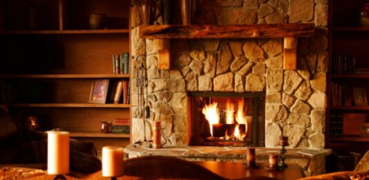 How to Choose the Perfect Fireplace for Your Home brown wooden table with white pillar candles