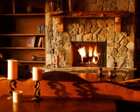 How to Choose the Perfect Fireplace for Your Home brown wooden table with white pillar candles