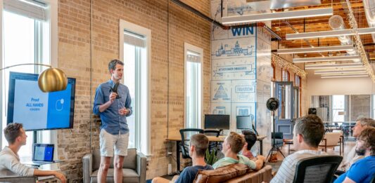 5 Benefits of Team Building Activities man standing in front of group of men
