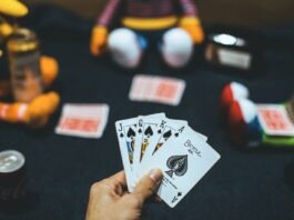How To Choose A Reputable Real Money Casino: Tips And Tricks person holding playing cards near red and white ball