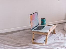5 Best Ways To Support Your Remote Working Employees macbook pro on white wooden table