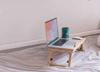 5 Best Ways To Support Your Remote Working Employees macbook pro on white wooden table