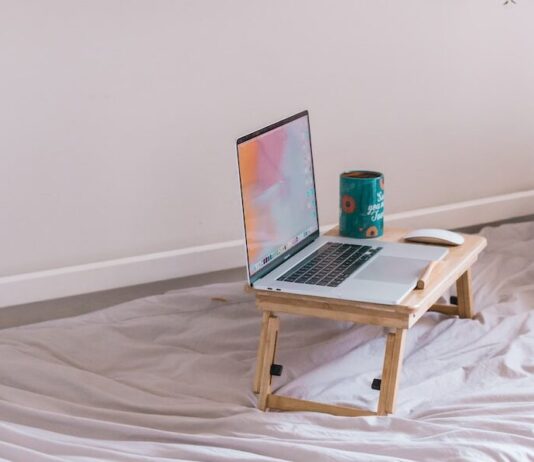 5 Best Ways To Support Your Remote Working Employees macbook pro on white wooden table