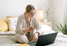 Coinitech.com Review Reveals How You Can Maximize Your Trading Potential Photo of Woman Sitting on Bed While Using Black Laptop