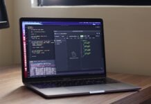 WebRTC API for Safe Video Conferencing a laptop computer sitting on top of a wooden desk