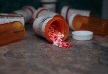 Blue vs. Yellow: What’s the Difference When It Comes to Xanax? a close up of a bottle of pills on a table
