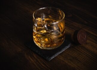 What are the Strategies When You Market Your Mobile Bartending Service? a glass of whiskey sitting on top of a wooden table