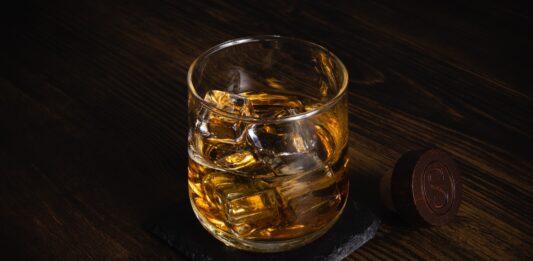 What are the Strategies When You Market Your Mobile Bartending Service? a glass of whiskey sitting on top of a wooden table