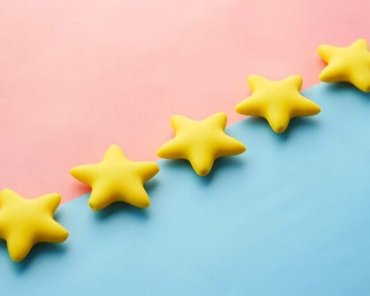 Quality First: The Science and Art of Ensuring Product Integrity a row of yellow stars sitting on top of a blue and pink surface