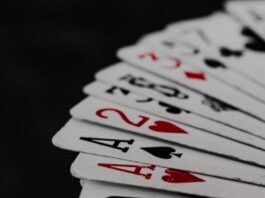 What is Rake in Online Poker, and How Does it Affect Your Winnings? a stack of playing cards sitting on top of each other