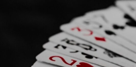 What is Rake in Online Poker, and How Does it Affect Your Winnings? a stack of playing cards sitting on top of each other