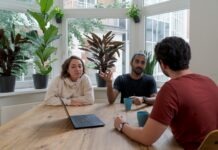 The Best Practices for Managing Stakeholder Expectations woman in white shirt sitting beside man in red crew neck t-shirt