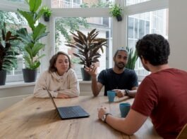 The Best Practices for Managing Stakeholder Expectations woman in white shirt sitting beside man in red crew neck t-shirt