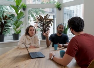 The Best Practices for Managing Stakeholder Expectations woman in white shirt sitting beside man in red crew neck t-shirt