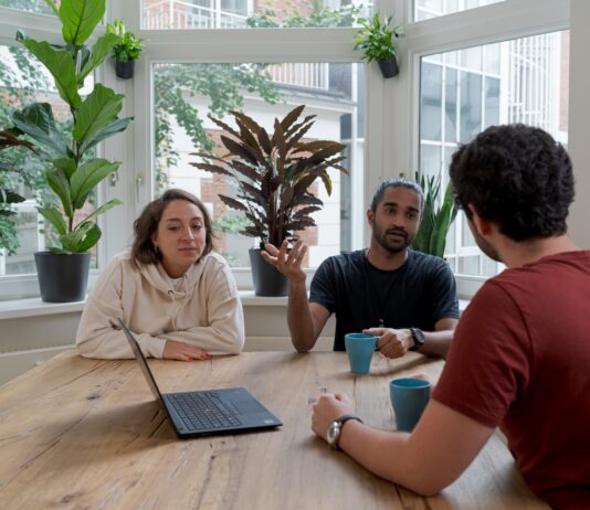 The Best Practices for Managing Stakeholder Expectations woman in white shirt sitting beside man in red crew neck t-shirt